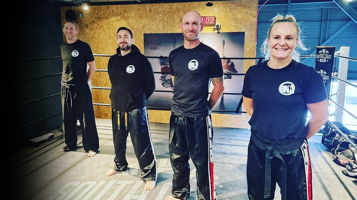 Michelle Biggs and three BKA instructors standing in the ring at South Coast Gym, Lancing